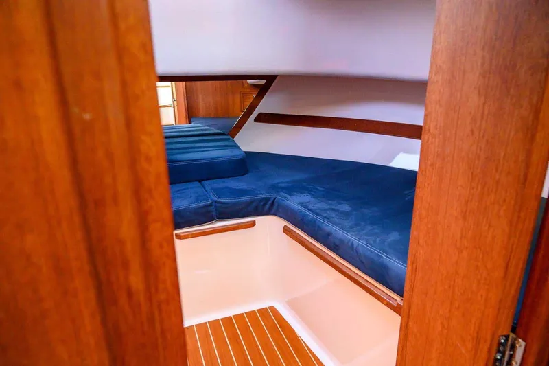 Slide: The Image of Cozy cabin interior of 2019 Nord Star 28 Patrol with blue cushions and wooden accents. - 39