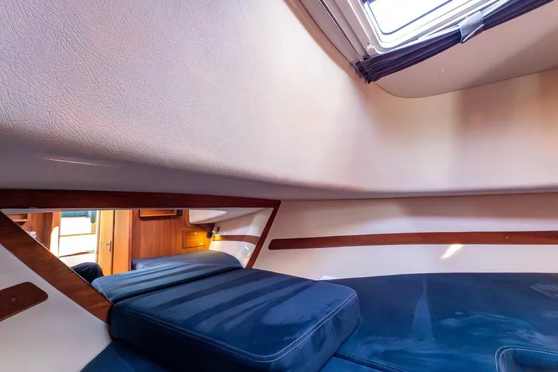 Slide: The Image of Interior cabin of 2019 Nord Star 28 Patrol boat with blue cushions and wooden accents. - 40