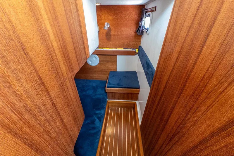 Slide: The Image of Interior cabin of 2019 Nord Star 28 Patrol with wooden finish and blue upholstery. - 44