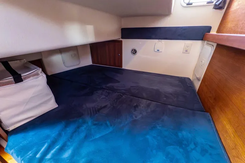 Slide: The Image of Cabin interior of 2019 Nord Star 28 Patrol boat with blue bedding. - 46