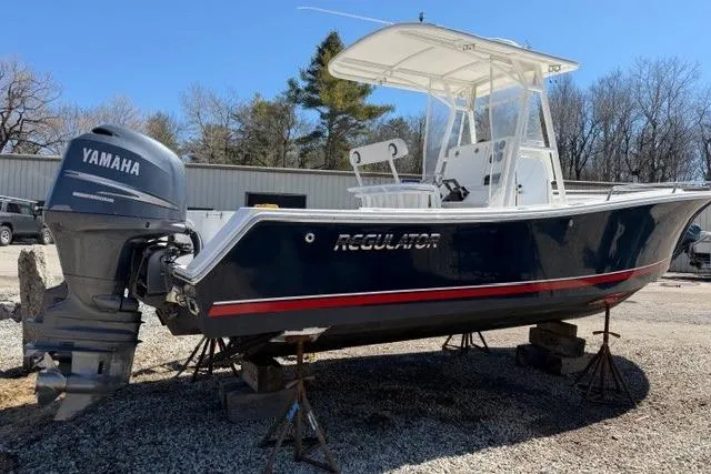 Slide: The Image of 2004 Regulator 24 Forward Seating boat with Yamaha outboard motor on stands. - 2