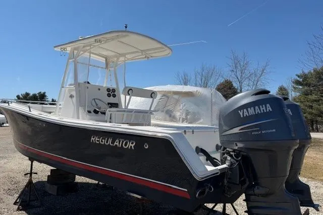 Slide: The Image of 2004 Regulator 24 Forward Seating boat with Yamaha outboard motor, displayed outdoors. - 3