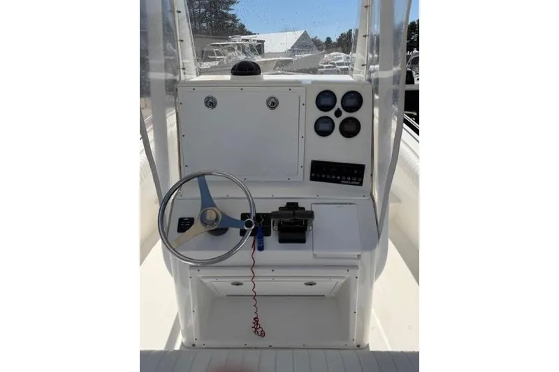 Slide: The Image of 2004 Regulator 24 Forward Seating boat console with steering wheel and gauges. - 8