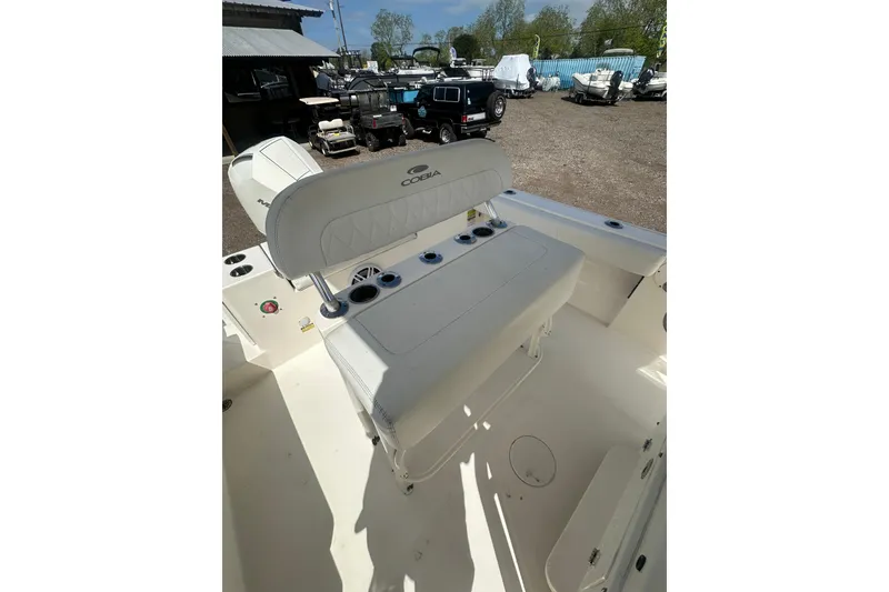 Slide: The Image of 2022 Cobia 220 Center Console boat interior with seating and cup holders. - 12