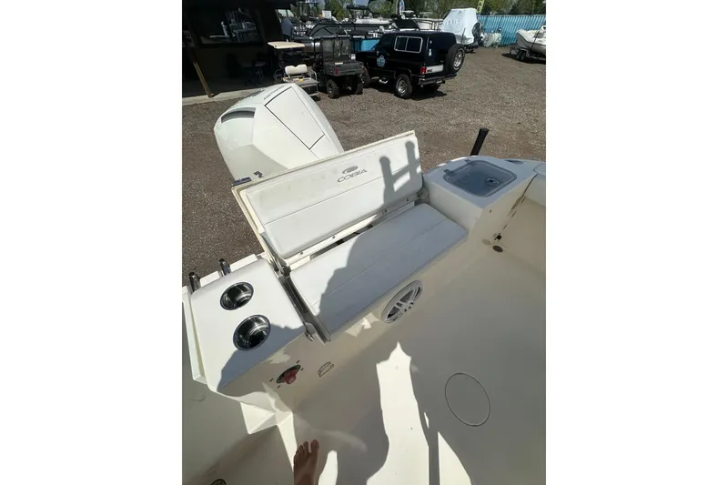 Slide: The Image of 2022 Cobia 220 Center Console boat interior with open storage and cup holders. - 13