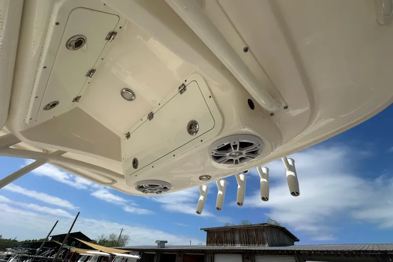 Slide: The Image of 2022 Cobia 220 Center Console boat underside with speakers and rod holders. - 17