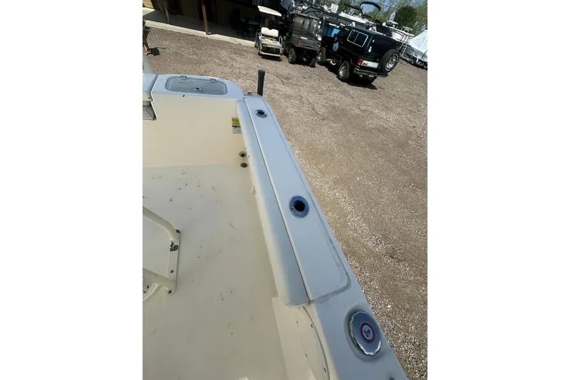 Slide: The Image of 2022 Cobia 220 Center Console boat interior with visible deck and rod holders. - 19