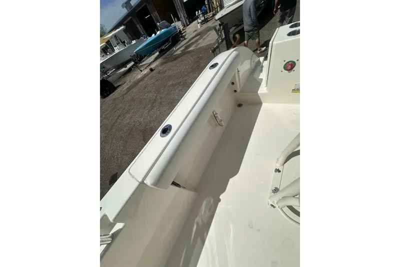 Slide: The Image of 2022 Cobia 220 Center Console boat interior with seating and deck view. - 20