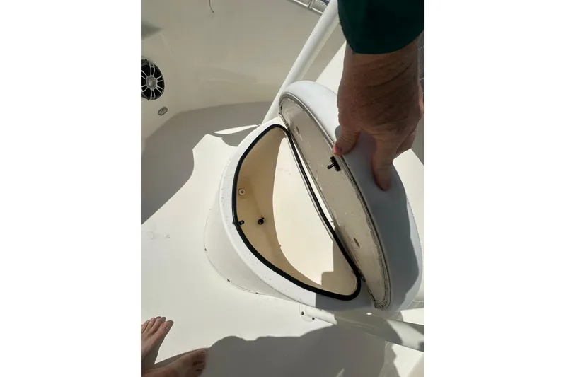 Slide: The Image of Open storage compartment on a 2022 Cobia 220 Center Console boat. - 22