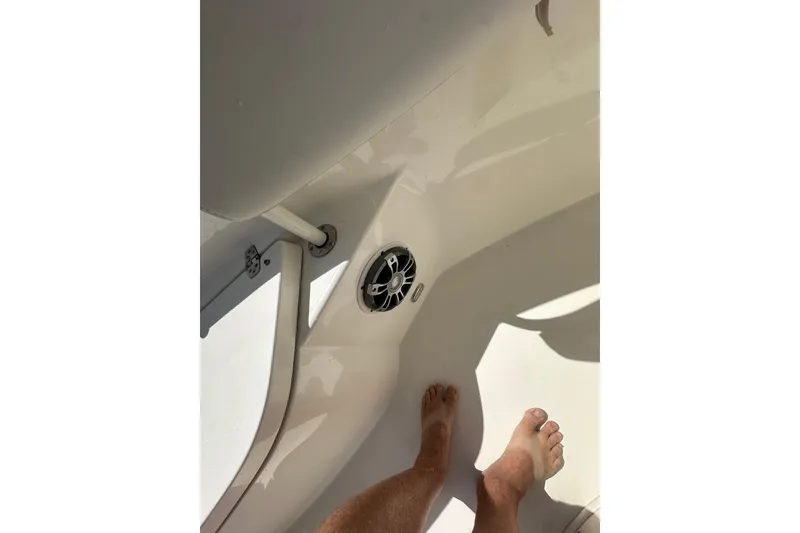 Slide: The Image of Interior view of 2022 Cobia 220 Center Console boat with visible speaker and feet. - 23