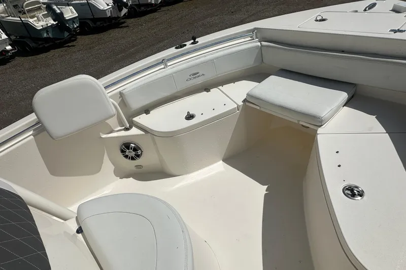 Slide: The Image of 2022 Cobia 220 Center Console boat interior with seating and storage compartments. - 26
