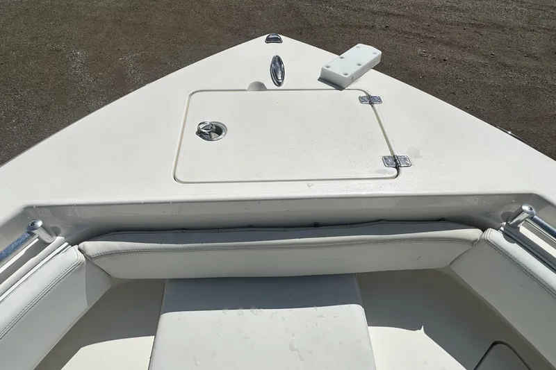 Slide: The Image of 2022 Cobia 220 Center Console boat bow with seating and storage compartment. - 27