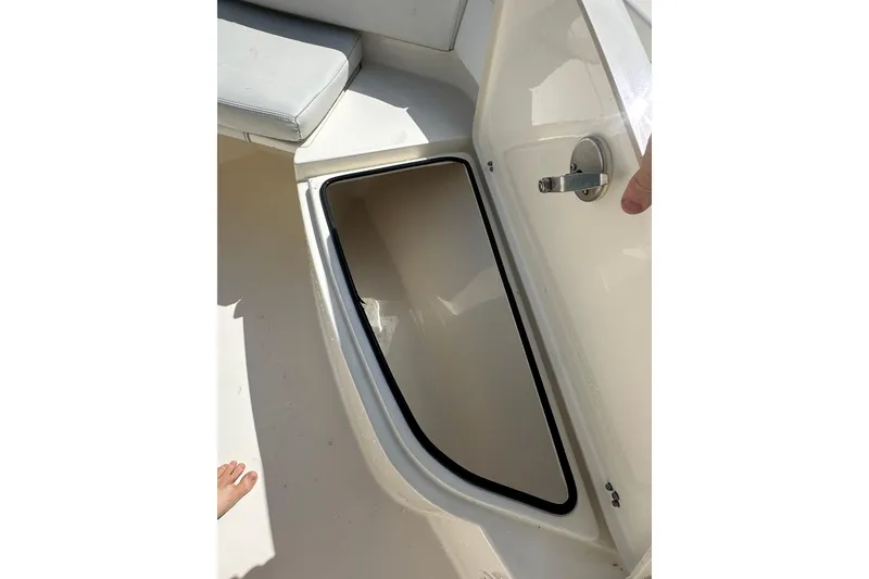 Slide: The Image of Open storage compartment on 2022 Cobia 220 Center Console boat. - 29
