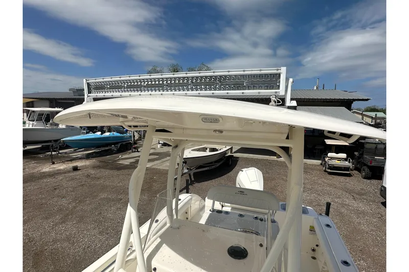Slide: The Image of 2022 Cobia 220 Center Console boat with T-top and LED light bar. - 31