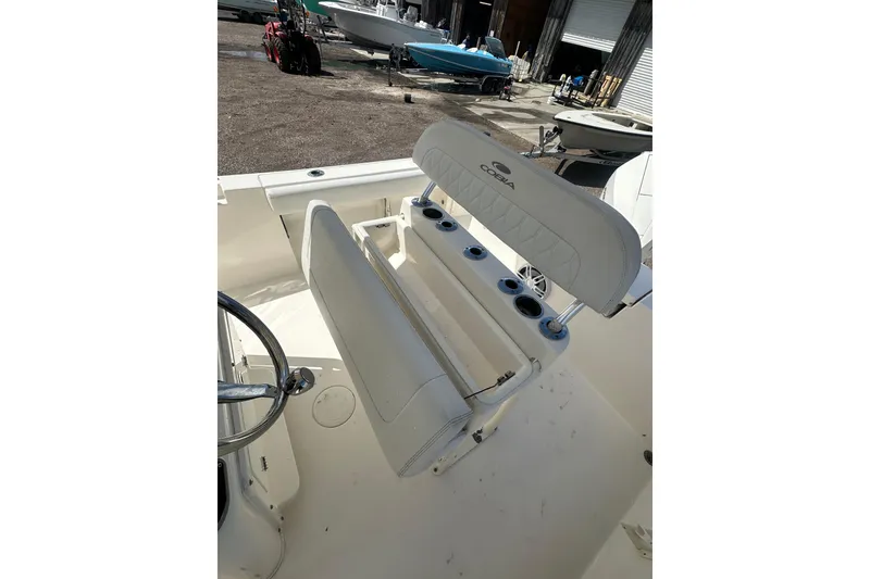 Slide: The Image of 2022 Cobia 220 Center Console boat interior with seating and steering wheel. - 32