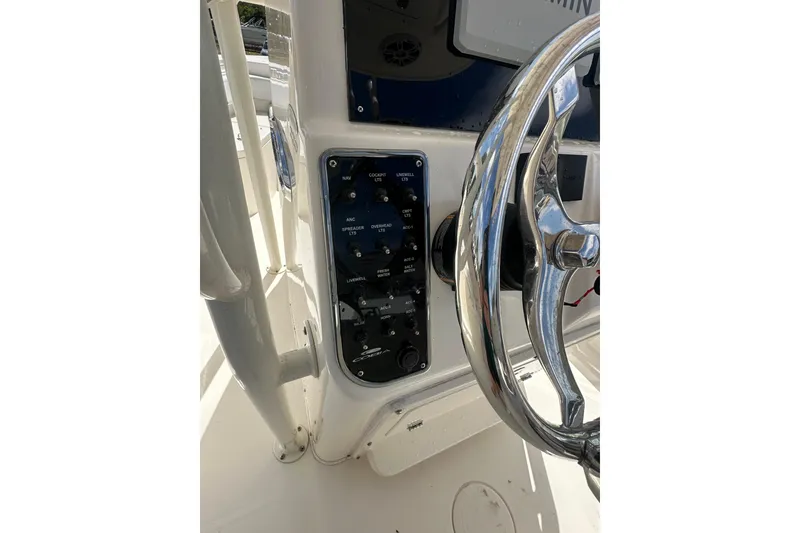 Slide: The Image of Control panel and steering wheel of 2022 Cobia 220 Center Console boat. - 35