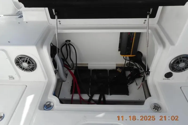 Slide: The Image of Open storage compartment on a 2026 Sea Fox 268 Traveler boat, showing wiring and speakers. - 11