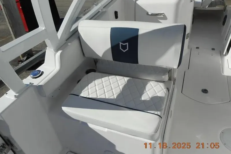 Slide: The Image of 2026 Sea Fox 268 Traveler boat seat with quilted white upholstery and blue accents. - 21