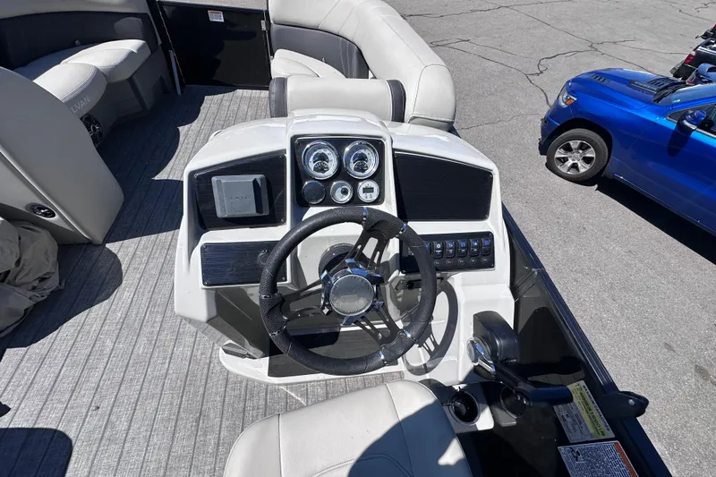 Slide: The Image of Cockpit view of 2021 Sylvan Mirage X X3 pontoon boat with steering wheel and control panel. - 13
