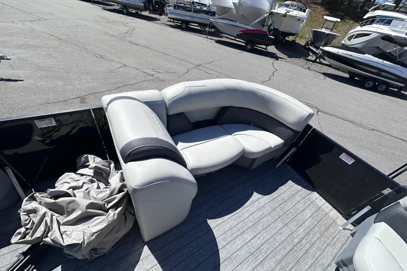 Slide: The Image of 2021 Sylvan Mirage X X3 pontoon boat with plush seating, docked among other boats. - 15