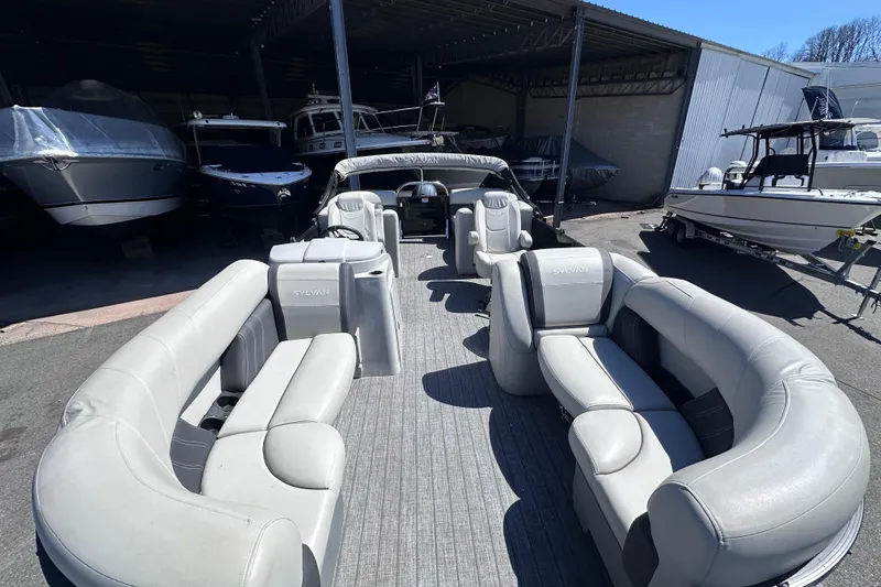 Slide: The Image of 2021 Sylvan Mirage X X3 pontoon boat with spacious seating in a storage area. - 17