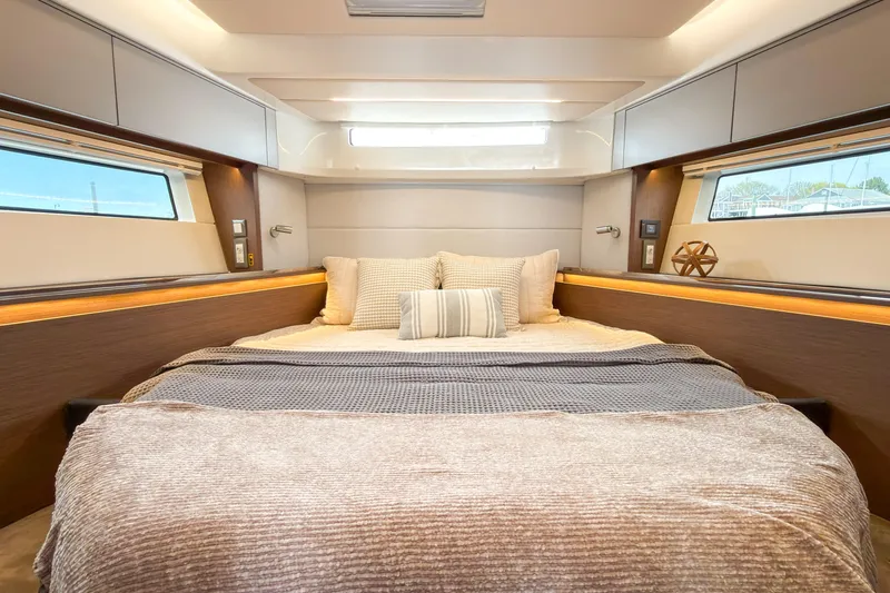 Slide: The Image of Luxurious cabin interior of 2026 Beneteau Antares 12 Coupe yacht, featuring elegant bedding. - 10
