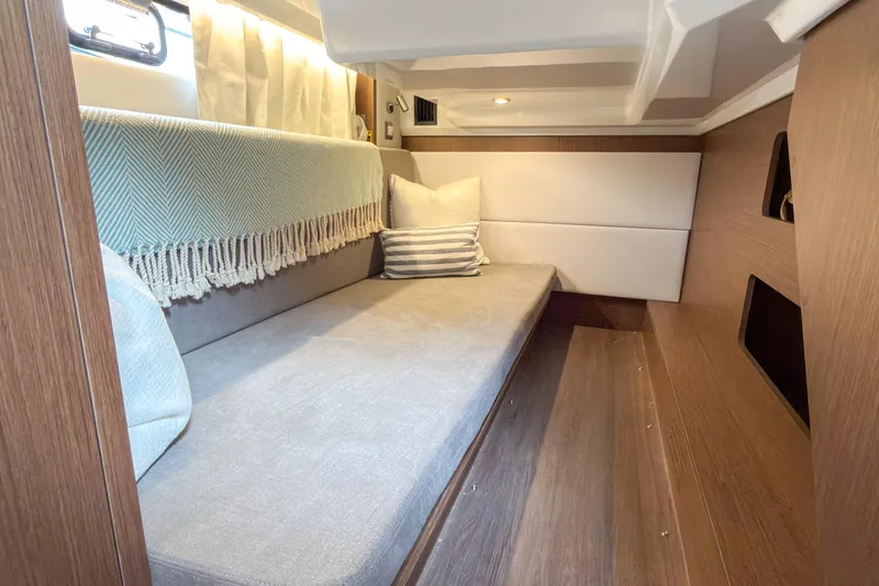 Slide: The Image of Cozy interior cabin of 2026 Beneteau Antares 12 Coupe with elegant wood finish. - 13