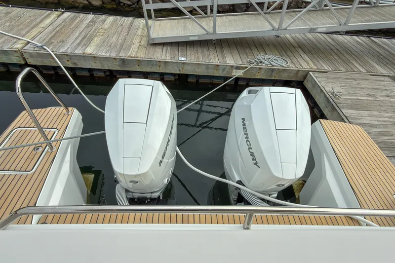 Slide: The Image of 2026 Beneteau Antares 12 Coupe with twin Mercury outboard engines at dock. - 14