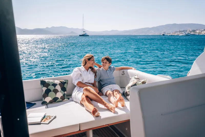 Slide: The Image of Woman and child relaxing on a 2026 Beneteau Antares 12 yacht, scenic ocean view. - 16