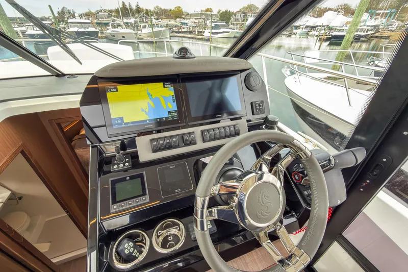 Slide: The Image of Cockpit of 2026 Beneteau Antares 12 Coupe with advanced navigation system and steering wheel. - 6