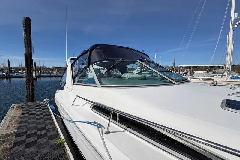 Slide: The Image of 1993 Sea Ray Sundancer 330 docked at marina under clear blue sky. - 10