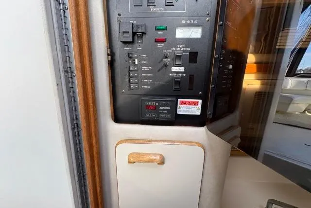 Slide: The Image of Control panel inside a 1993 Sea Ray Sundancer 330 boat, featuring various switches and indicators. - 103