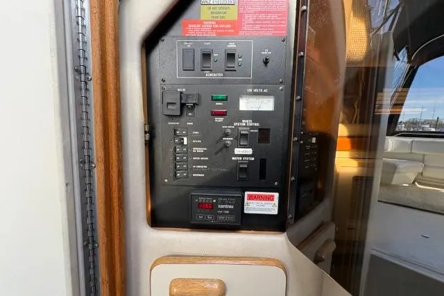 Slide: The Image of 1993 Sea Ray Sundancer 330 control panel with switches and warning labels. - 104