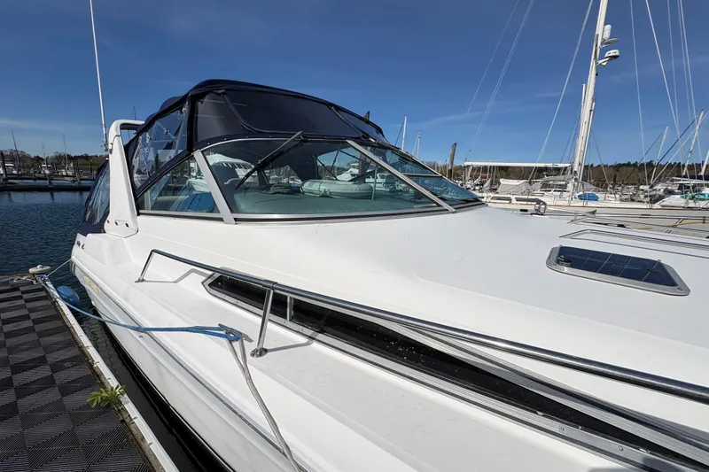 Slide: The Image of 1993 Sea Ray Sundancer 330 yacht docked at marina under clear blue sky. - 11