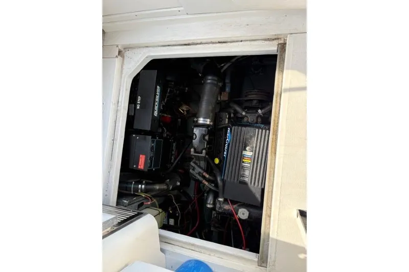 Slide: The Image of Engine compartment of a 1993 Sea Ray Sundancer 330 boat, showcasing mechanical components. - 110