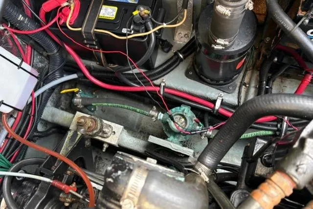 Slide: The Image of Engine compartment of a 1993 Sea Ray Sundancer 330 with visible wiring and components. - 114