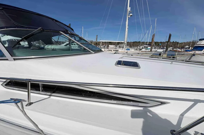Slide: The Image of 1993 Sea Ray Sundancer 330 yacht docked at marina under clear blue sky. - 12