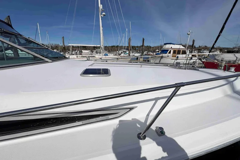 Slide: The Image of 1993 Sea Ray Sundancer 330 yacht docked at marina, showcasing sleek deck design. - 13