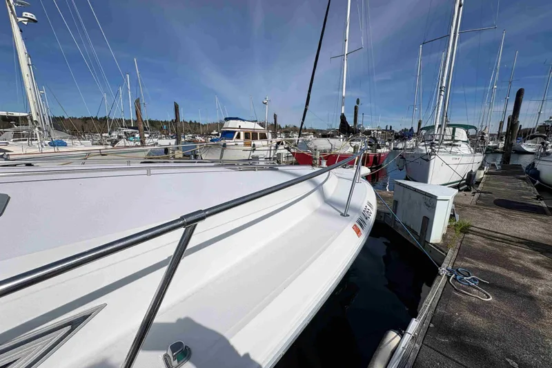 Slide: The Image of 1993 Sea Ray Sundancer 330 docked at a marina, surrounded by other boats. - 14