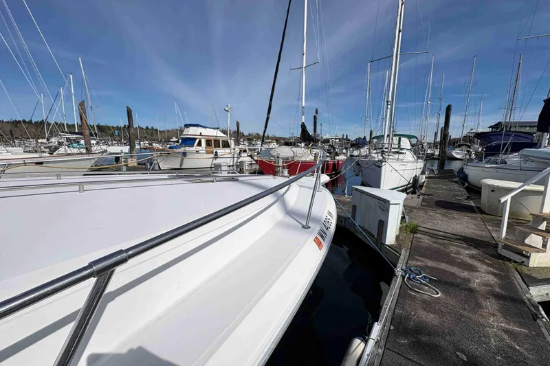 Slide: The Image of 1993 Sea Ray Sundancer 330 docked in a marina, surrounded by various boats under a clear sky. - 15