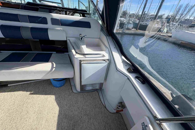 Slide: The Image of Interior of 1993 Sea Ray Sundancer 330 with seating and sink, docked at marina. - 22