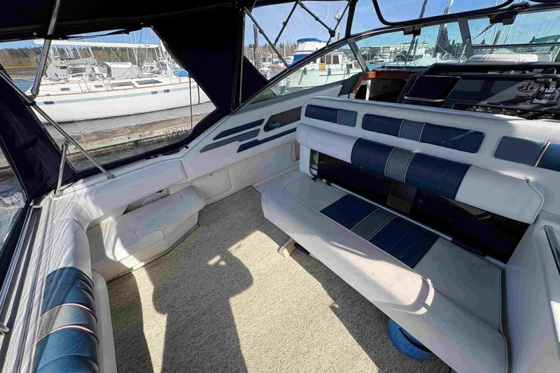 Slide: The Image of Interior of a 1993 Sea Ray Sundancer 330 boat with blue and white seating. - 23