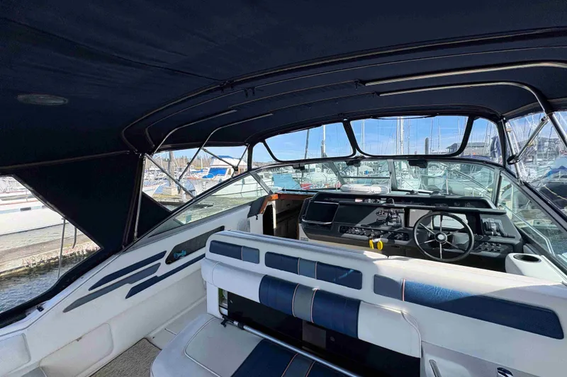 Slide: The Image of Interior view of a 1993 Sea Ray Sundancer 330 boat at a marina. - 26