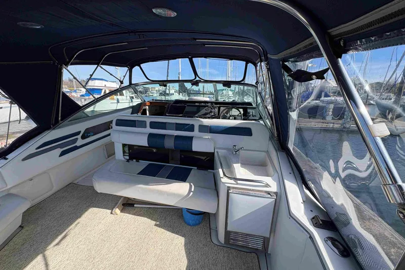 Slide: The Image of Interior view of a 1993 Sea Ray Sundancer 330 boat, featuring seating and helm. - 27
