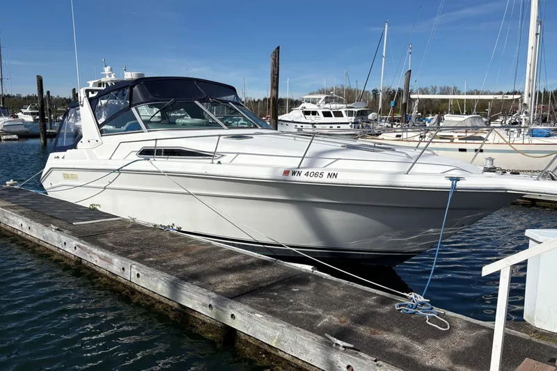 Slide: The Image of 1993 Sea Ray Sundancer 330 docked at a marina under clear blue skies. - 3