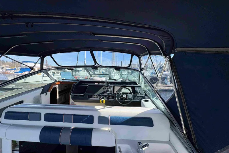 Slide: The Image of Interior view of 1993 Sea Ray Sundancer 330 boat with steering wheel and seating. - 31