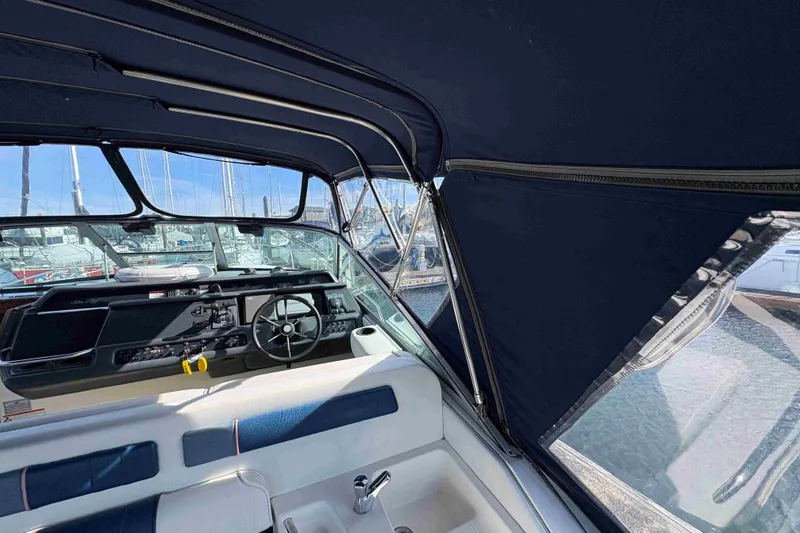 Slide: The Image of Interior view of 1993 Sea Ray Sundancer 330 boat with steering wheel and canopy. - 32