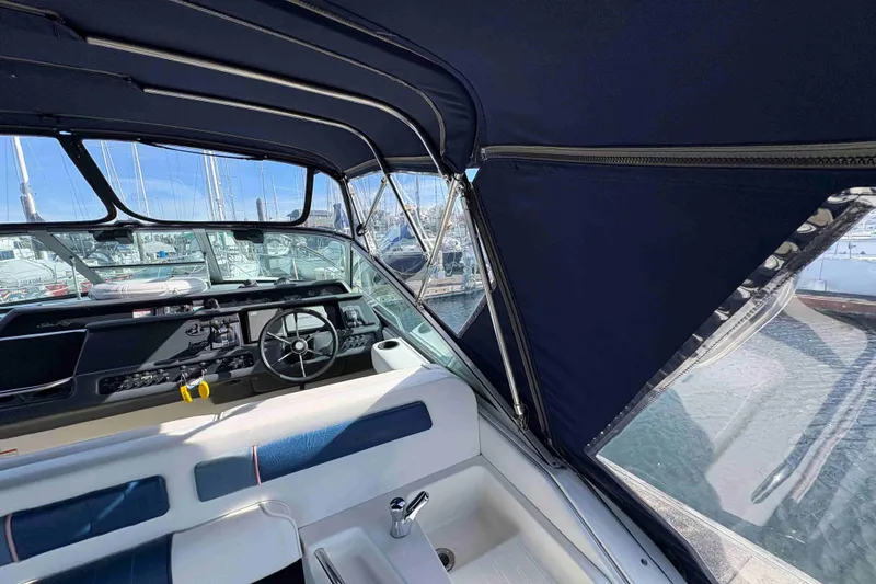 Slide: The Image of Interior view of 1993 Sea Ray Sundancer 330 boat with steering wheel and canopy. - 33