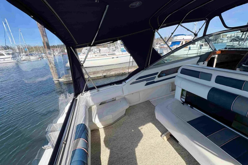 Slide: The Image of 1993 Sea Ray Sundancer 330 interior with seating, docked at marina. - 35