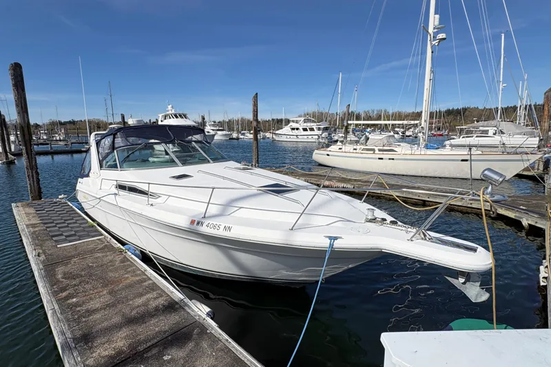 Slide: The Image of 1993 Sea Ray Sundancer 330 docked at a marina, surrounded by other boats. - 4